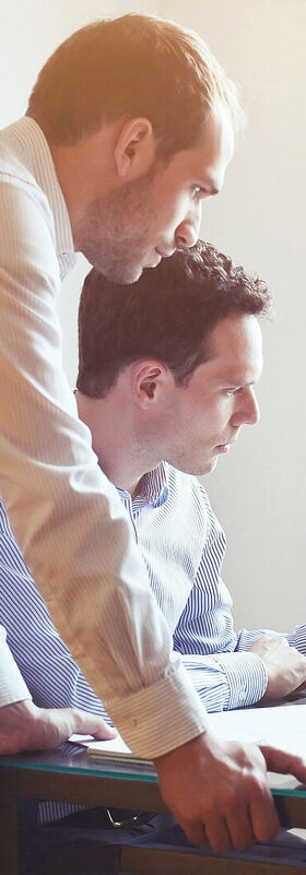 A group of business people working together on a laptop with big data analytics tools by T Business.
