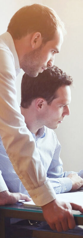 A group of business people working together on a laptop with big data analytics tools by T Business.