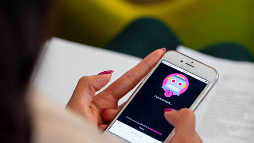 Digital Transformation in Banking & Insurance Industry A woman looking at her smartphone at Digital Transformation in Banking & Insurance Industry