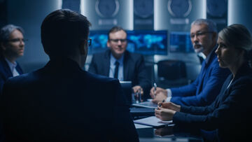 Security risks Security experts use T Business solutions in a meeting to identify security risks.