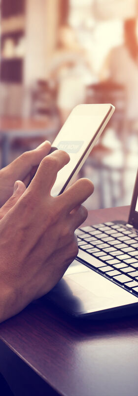 The hand of a man using his smartphone for online payments as an example of the digital transformation of government