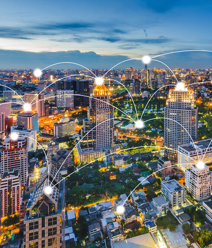 SD-X A metropolis is depicted, with individual residences connected by a stylized communication network to illustrate site networking with SD-X by T Business.