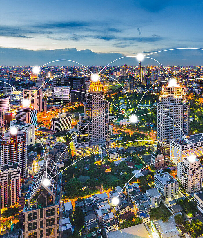 SD-X A metropolis is depicted, with individual residences connected by a stylized communication network to illustrate site networking with SD-X by T Business.