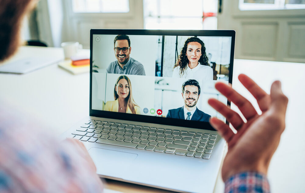 Small Business IT Solutions Business people talking about small business IT solutions remotely on their laptops