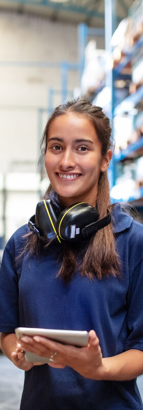 Female factory employee with a digital tablet looking for banking and financial solutions