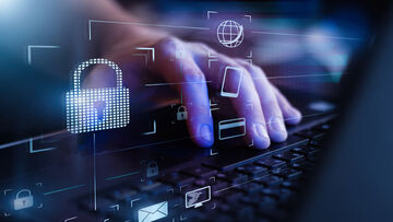 Business IT security A hand on a laptop keyboard in the background, with icons such as a lock, globes and envelopes in front of it symbolizing business IT security solutions from T Business.