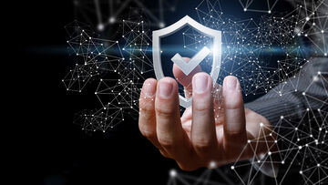 Security risks A hand holds up a symbolic shield, symbolizing the full security assessment with T Business solutions that identify security risks.