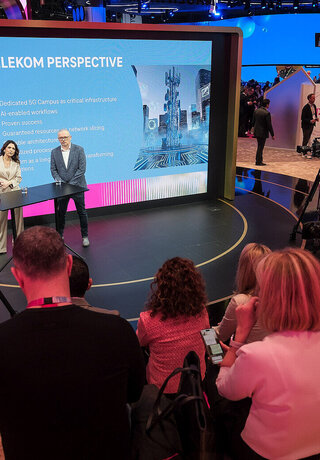 Marijana Bačić, Marin Tica and Mirela Seserko on a stage in front of a large screen titled "Telekom Perspective," which lists bullet points about 5G and AI-enabled workflows at the Mobile World Congress (MWC) 2026.