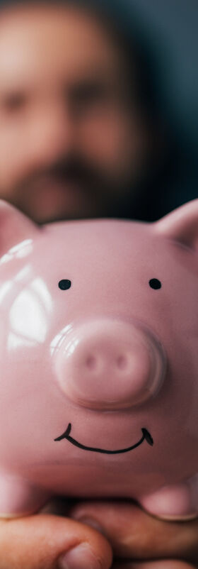 Cloud readiness A smiling piggy bank is held up after saving money and driving growth with cloud readiness, a T Business solution.