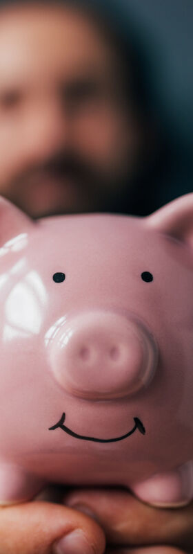 Cloud readiness A smiling piggy bank is held up after saving money and driving growth with cloud readiness, a T Business solution.