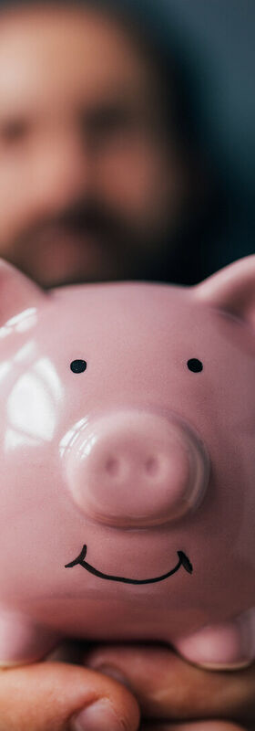 Cloud readiness A smiling piggy bank is held up after saving money and driving growth with cloud readiness, a T Business solution.