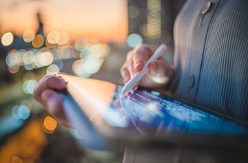 Small Business Communication Platform A person using the communication platform from T Business on her tablet.