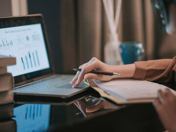 A woman looks at data on the government's digital transformation on her laptop