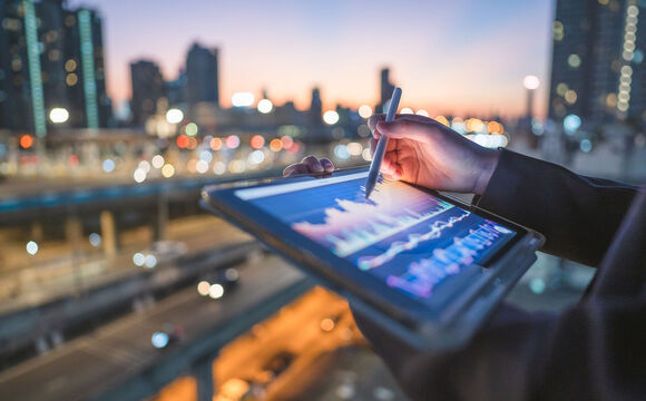 Close-up engineer coding digital data from a tablet AI representing technology trends in the finance and banking industry.