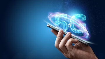 IoT ecosystem A hand holding a smartphone with the text "5G" in the background, visualizing 5G solutions by T Business for the IoT ecosystem.