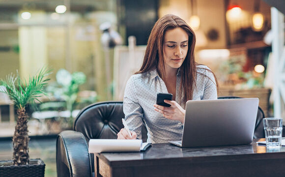 Young businesswoman working in the lobby with Meraki managed WiFi