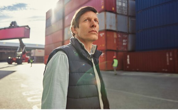 A man at a port thinking about digitalization | T Business