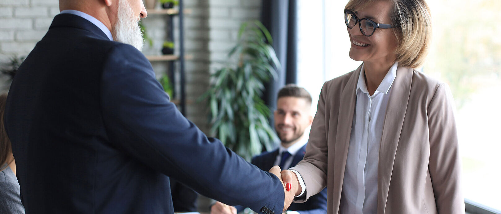 Business people shaking hands, finishing up a meeting.