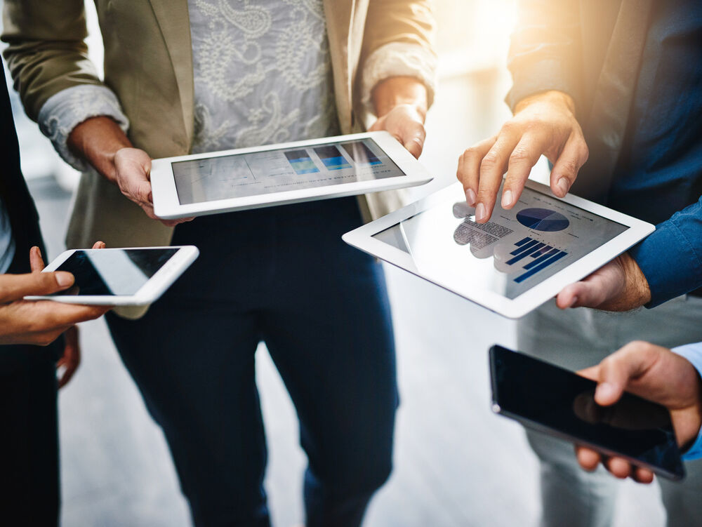 Connectivity solutions Business people with laptops and smartphones communicate with seamless connectivity solutions from T Business.