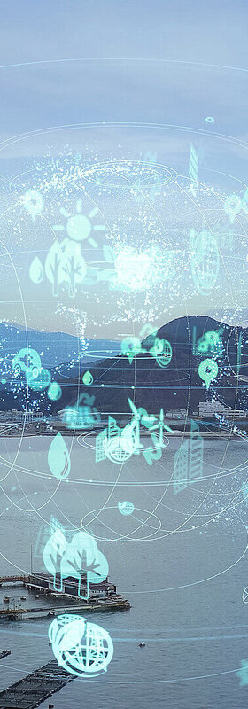 A photograph of a mountain panorama with cities and lakes, over which a stylized globe with sustainability symbols is placed, visualizes T Business' sustainable digitalization solutions.