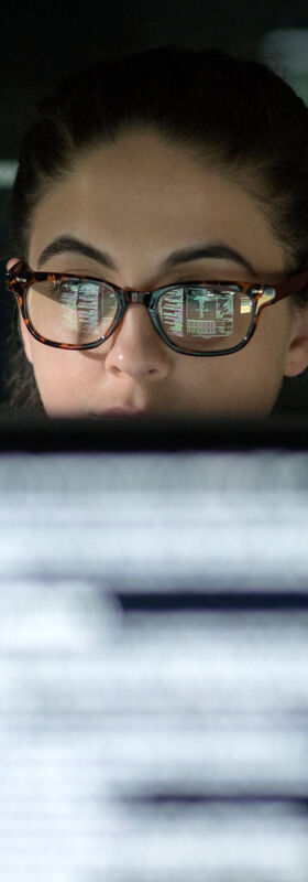 Business IT security An IT specialist works on a computer with business IT security solutions from T Business.