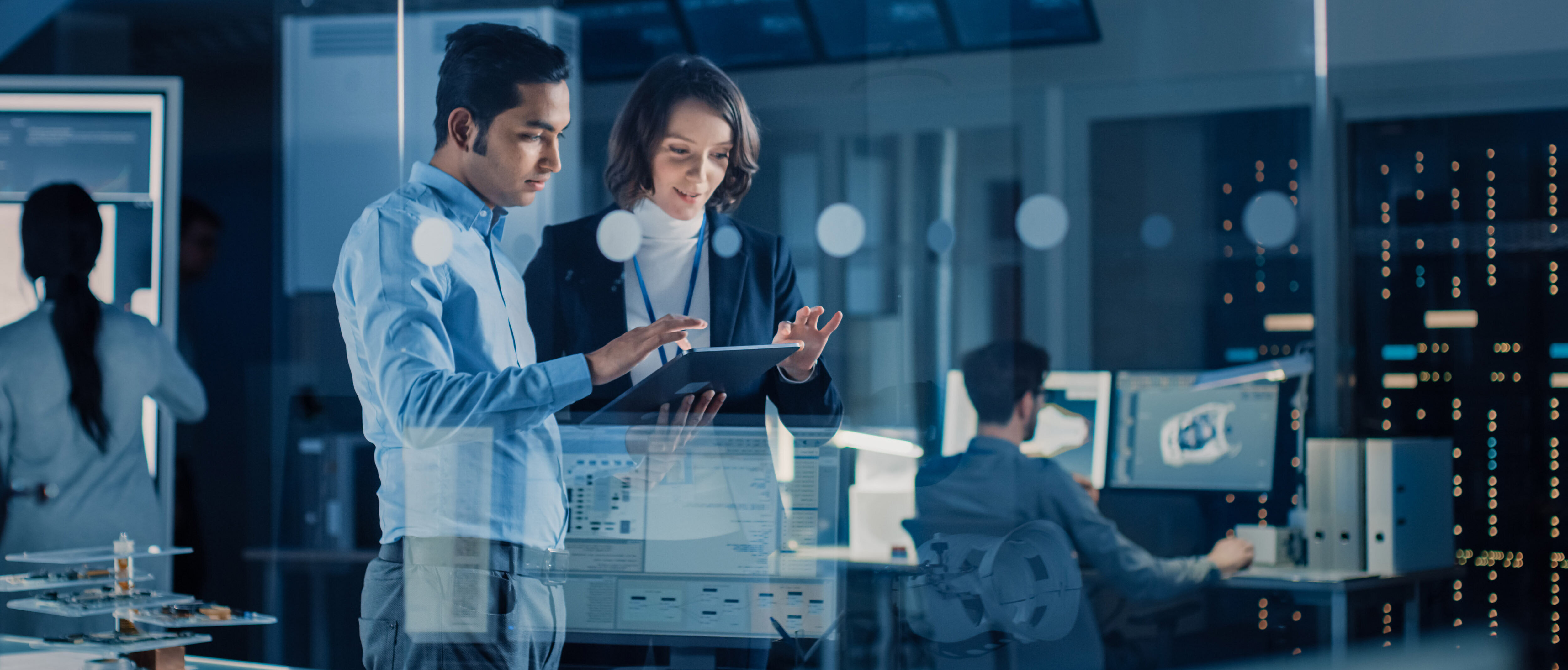 Project Manager talks with her Chief Engineer about IT solutions for their enterprise, while holding a tablet