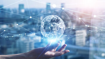 SD-X One hand is depicted holding up an abstract globe on which a communication network is stylized to illustrate site networking with SD-X by T Business.