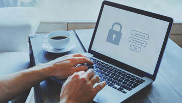 Data security A businessman works from his home office on his laptop via a T Business VPN, ensuring data security.