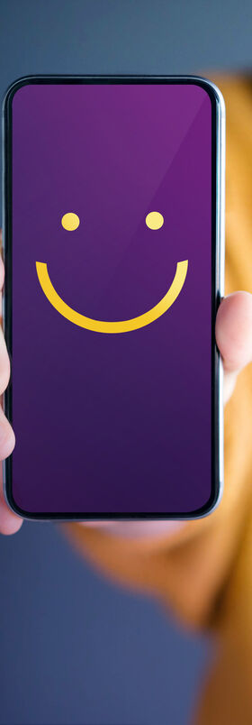 Girl showing her smartphone, that can be used for banking and financial solutions