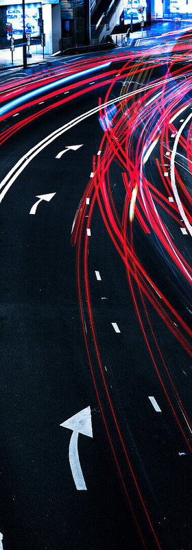A road with blurred lights from cars symbolizes the governance concept of cloud readiness, a T Business solution.