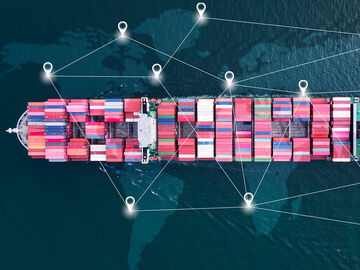 Logistics IT Solutions A bird's eye view of a container ship surrounded by a virtual data network consisting of logistics IT solutions