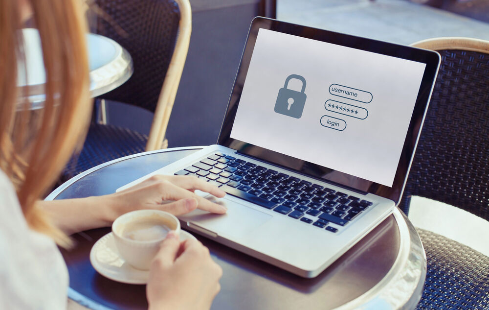 Small Business IT Solutions A woman in a café looking for IT solutions for her small business on her laptop