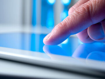 Hospitality IT Solutions A person looking on the tablet for hospitality IT solutions