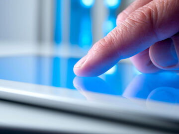 Hospitality IT Solutions A person looking on the tablet for hospitality IT solutions