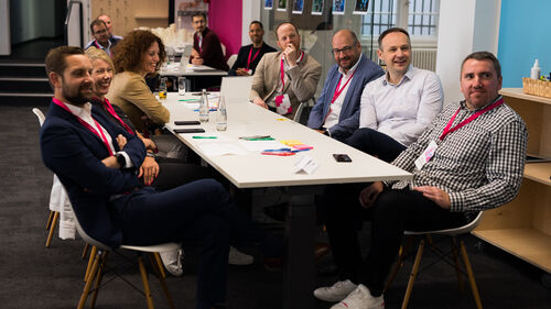 Digital Transformation in Banking & Insurance Industry People sitting at a table at Digital Transformation in Banking & Insurance Industry