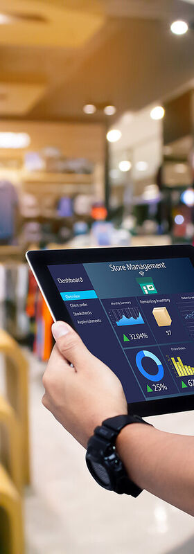 A store associate works on a tablet with sustainable digitalization solutions from T Business.