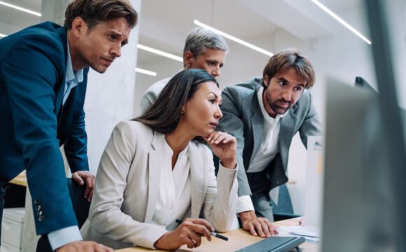 People searching on a computer for cyber security solutions