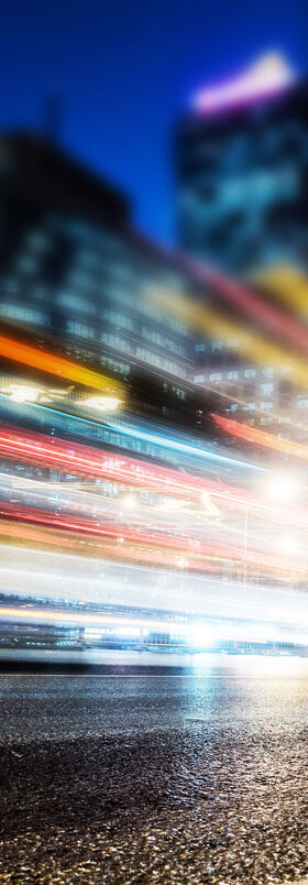 Connectivity solutions Blurred lights of passing cars in a city at night symbolize how internet access can be supercharged with connectivity solutions from T Business.