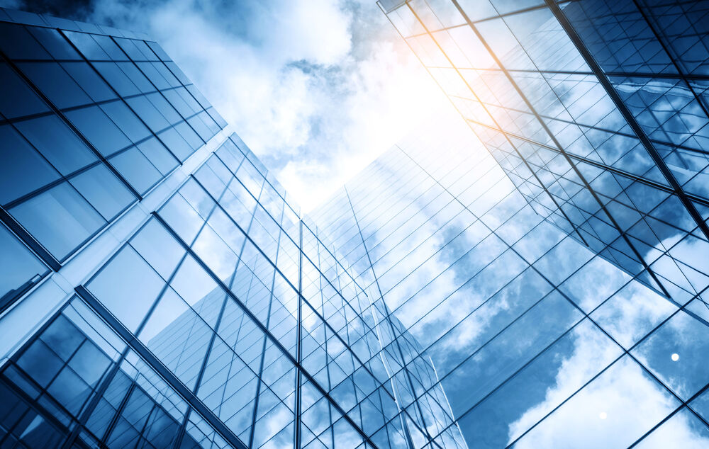 Cloud Computing Clouds are reflected in a modern skyscraper: evaluate your cloud readiness with cloud computing by T Business.