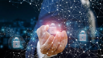 Data security A hand touches a padlock in a stylized network to symbolize an intrusion prevention system, a data security solution from T Business.
