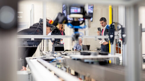 Digital Transformation of Manufacturing Industry A person taking a photo of the presented technology at Digital Transformation of Manufacturing Industry