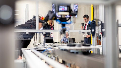 Digital Transformation of Manufacturing Industry A person taking a photo of the presented technology at Digital Transformation of Manufacturing Industry