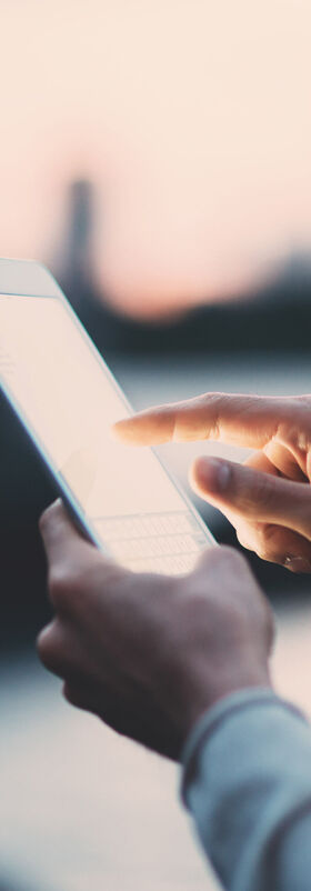Fast internet connection A man with a tablet is happy about the fast Internet connection from T Business.