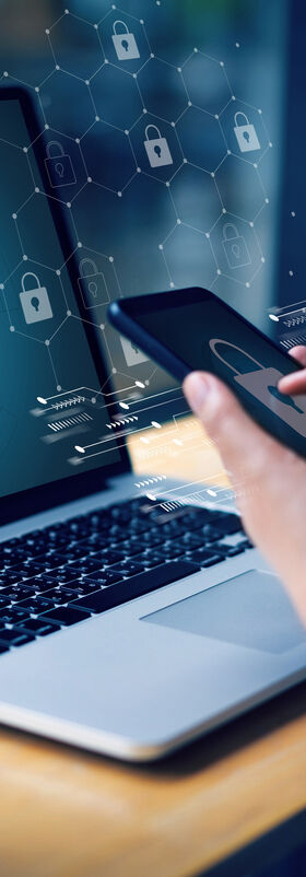 Remote Working Solutions A person sitting in a cafe and using their laptop and smartphone for remote working solutions