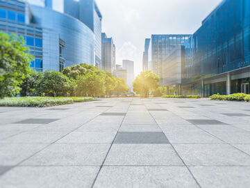 An empty brick floor with modern buildings in a smart city