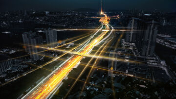 Secure Connectivity A city highway at night symbolizes a secure connectivity solution based on Multiprotocol Label Switching by T Business.