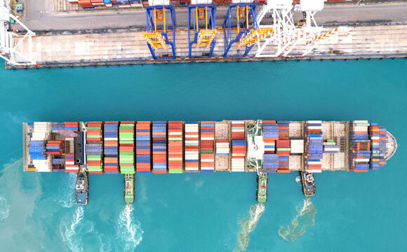 A container ship entering the port that works with connectivity solutions