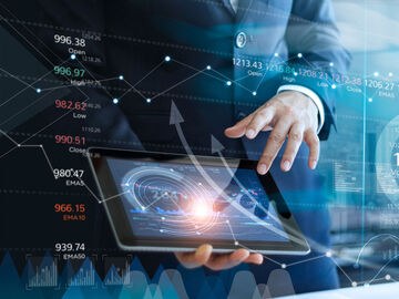 A businessman using his tablet to analyze data and economic growth of a smart city