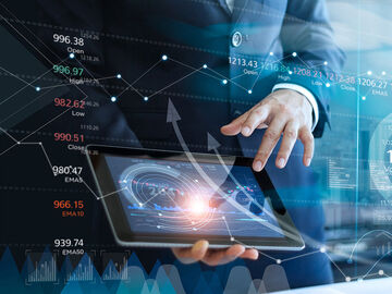 A businessman using his tablet to analyze data and economic growth of a smart city