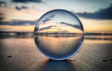Security risks A sunrise seen through a crystal ball symbolizes targeted vulnerability assessment with T Business solutions to minimize security risks.